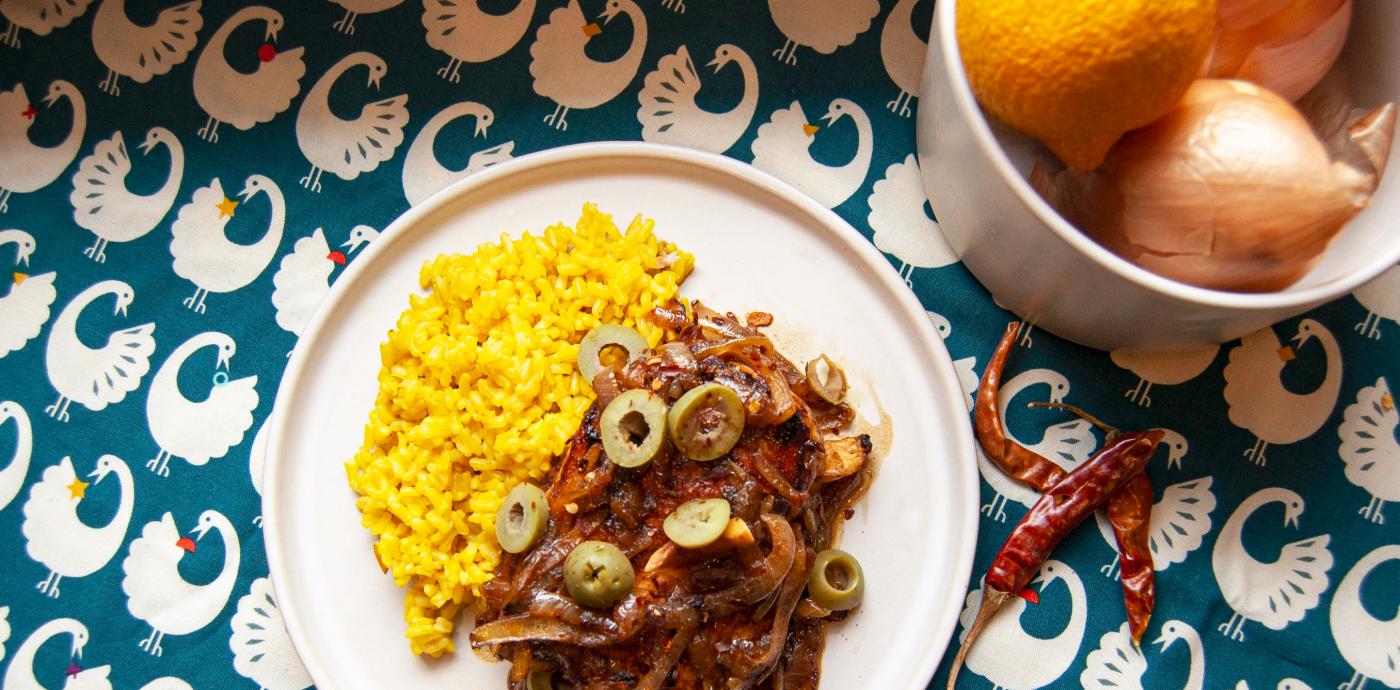 chicken yassa dish with blue patterned background