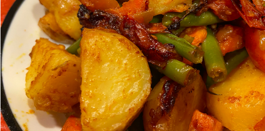 cooked potato wedges mixed with vegetables