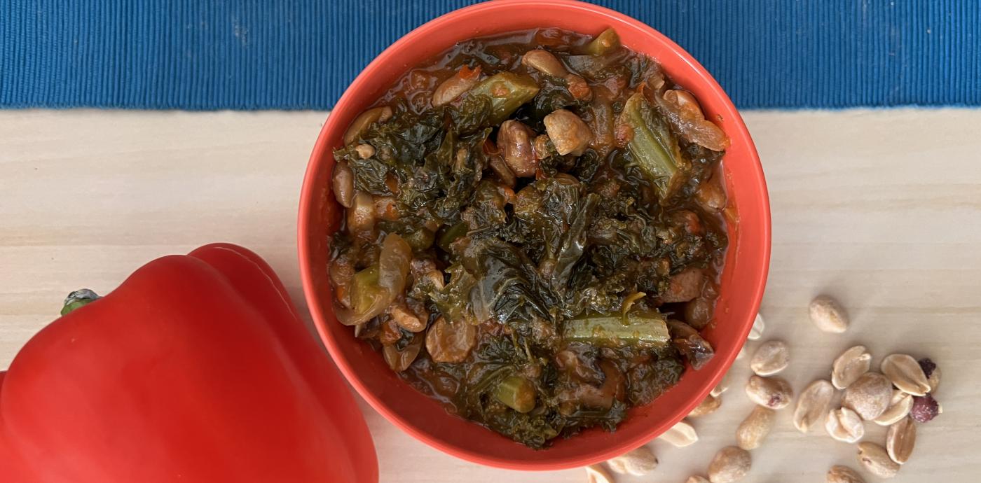 a red bowl filled with cooked greens