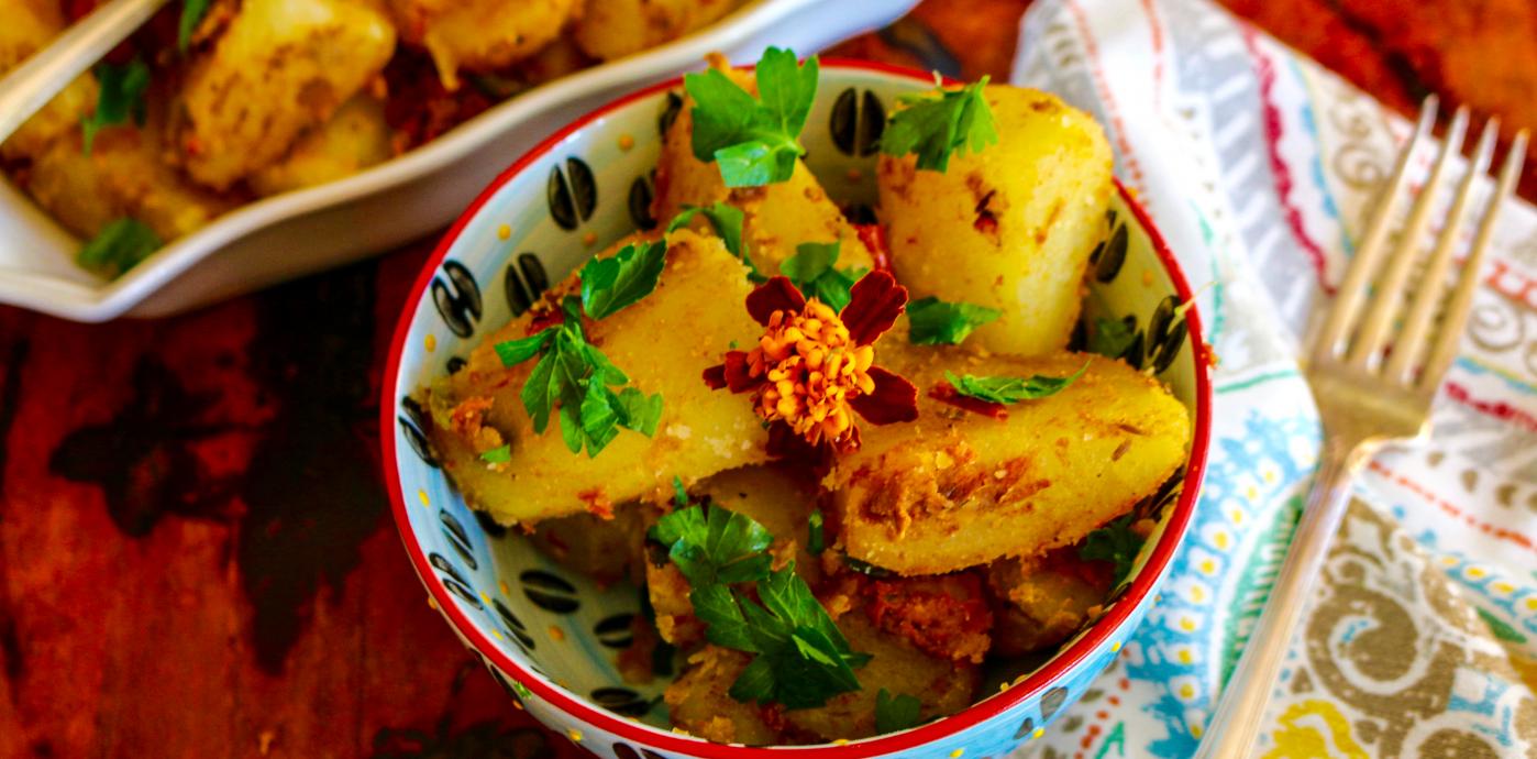 Potatoes with Indian spices in a dish with cilantro