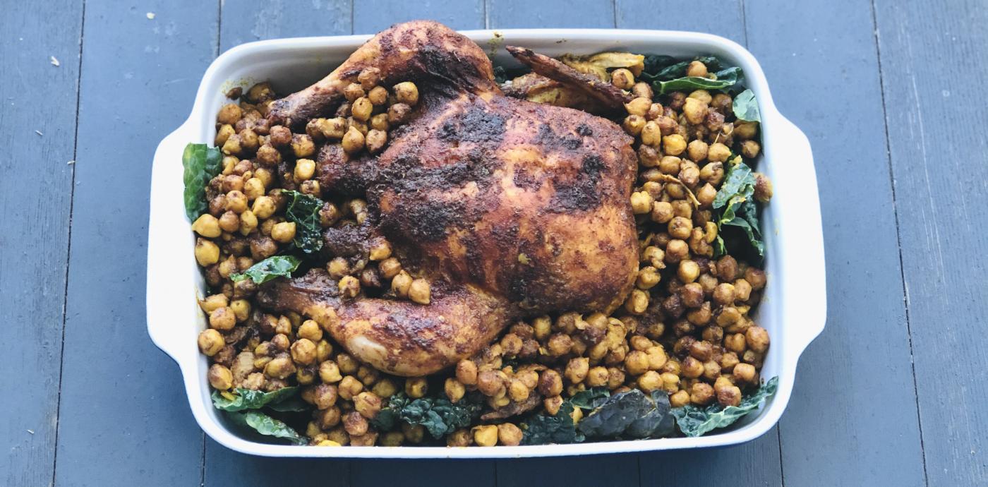roasted whole chicken over a bed of chickpeas and kale