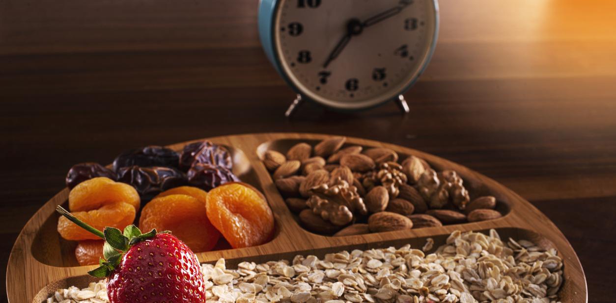 breakfast grains, dried fruit and clock istock