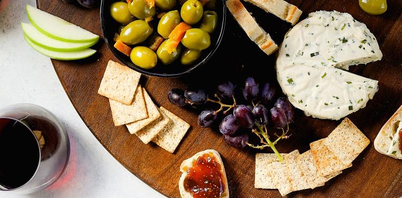 sweet and spicy cheese plate with olives and jam
