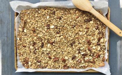 granola displayed on a parchment-lined baking sheet