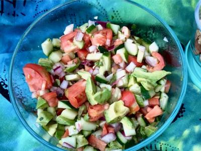 cucumber and tomato salad on a colorful blanket