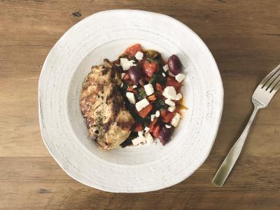 grilled chicken breast atop mixture of olives, feta, tomatoes, spinach