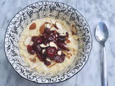 millet porridge topped with cherry compote and almonds