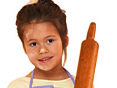 Little Girl in Apron Holding Rolling Pin