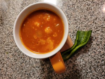 African vegetable medley soup in mug with pepper