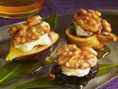 three figs stuffed with ricotta and topped with walnuts and honey