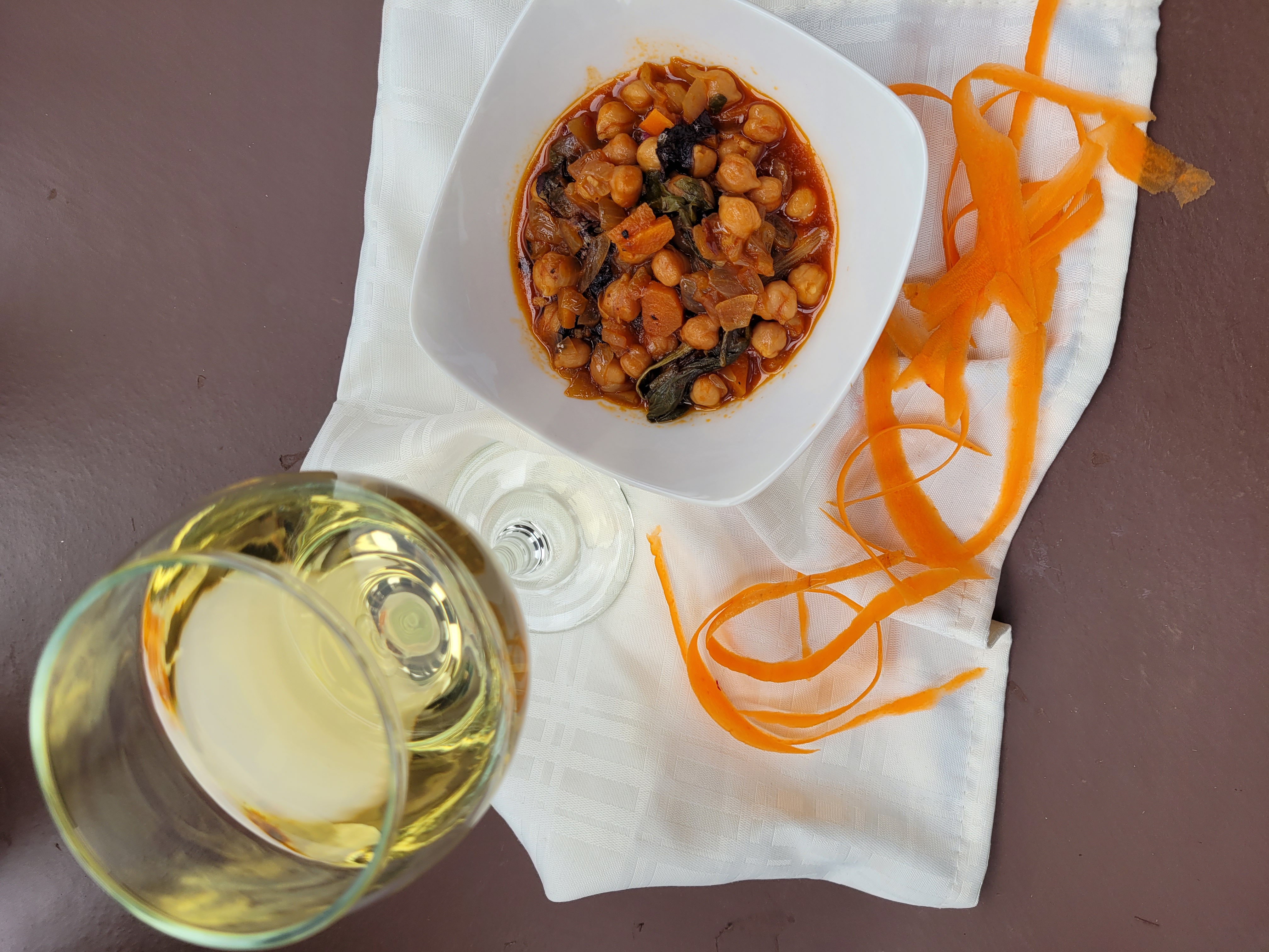 Chickpeas in a dish with a glass of wine