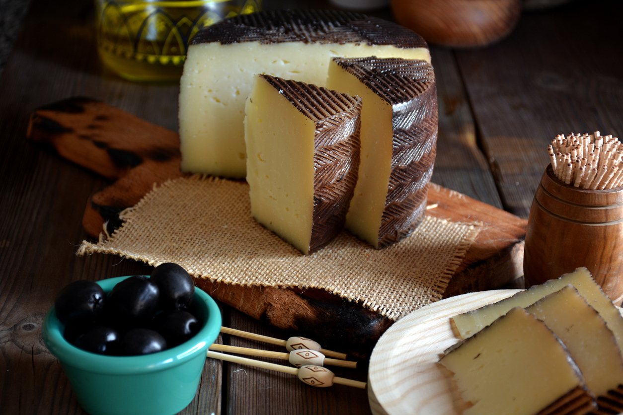 manchego cheese board with olives