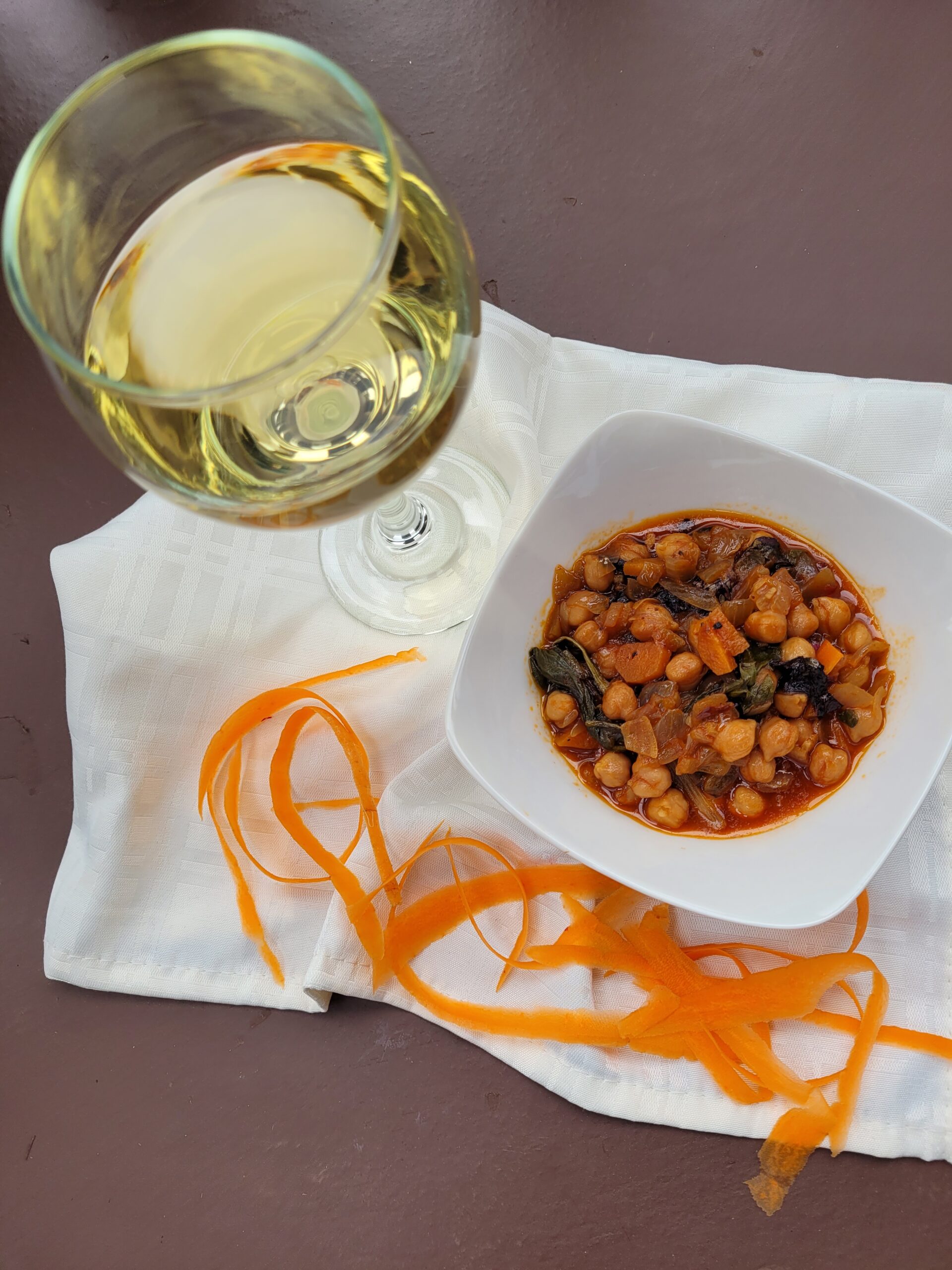 Chickpeas in a dish with a glass of wine