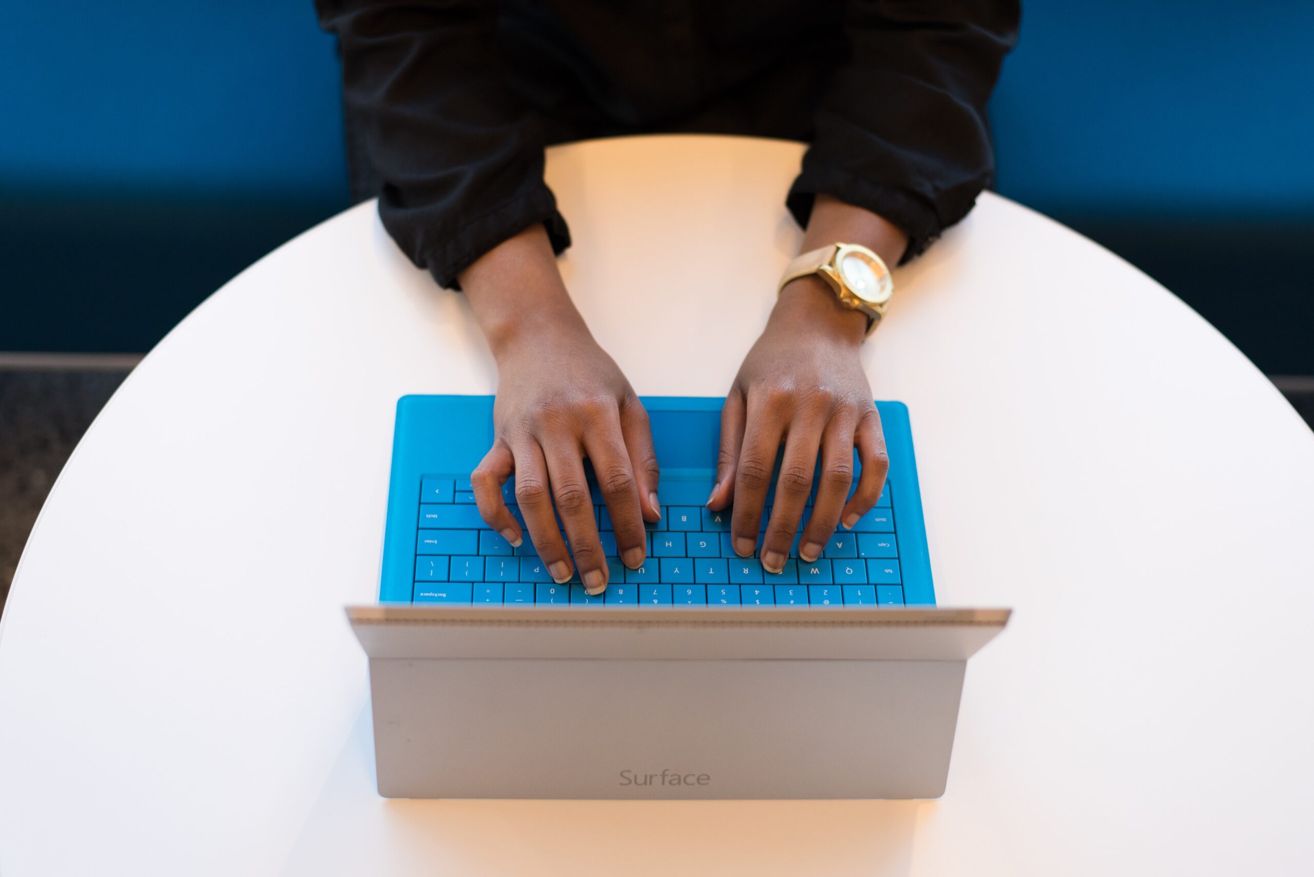 hands typing over the keys of a laptop