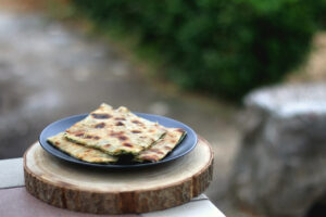 Thin dough filled with mangold, garlice and olive oil. Traditional food in Dalmatia, Croatia. Selective focus.