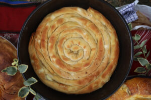 Freshly baked homemade bread arranged in traditional Bulgarian textiles. Image of some tasty Home-made bakery products.