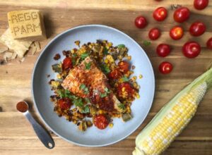 A delicious plate filled with golden corn, juicy tomatoes, and rich cheese