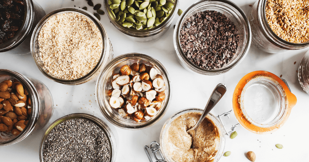 A collection of different nuts and seeds arranged, highlighting their unique colors and forms.