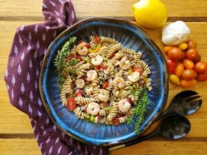 pasta salad featuring shrimp and fresh tomatoes