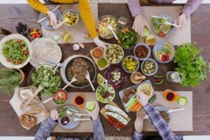 A diverse group of people enjoying a meal together around a table