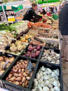 A lively market display overflowing with assorted fruits and vegetables
