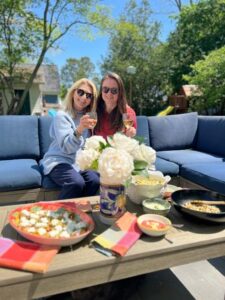 Two women enjoying a meal together at a patio table